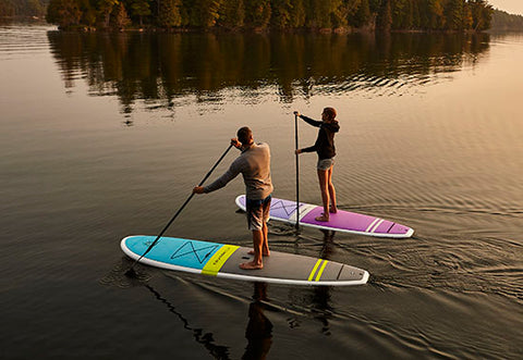 stand up paddle boarders on a lake