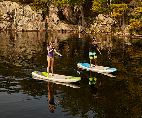 Stand up paddle boarders cruising in calm water