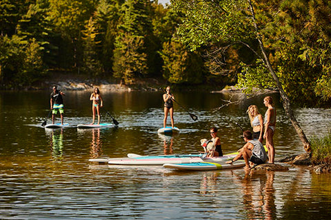 paddle boarders on a lake