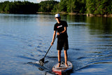 man stand up paddle boarding on Cruiser SUP® V-Max Woody 11'6 on a lake