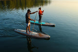 man and woman stand up paddle boarding on Cruiser SUP® Xplorer SE on a lake