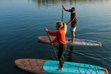 man and woman stand up paddle boarding on Cruiser SUP® Xplorer Classic on a lake