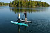 man and woman stand up paddle boarding on Cruiser SUP® Bliss LE on a lake