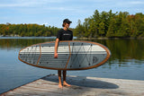 man carrying a Cruiser SUP® stand up paddle board - Xpedition Woody