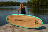 woman carrying a Cruiser SUP® stand up paddle board - Bliss LE