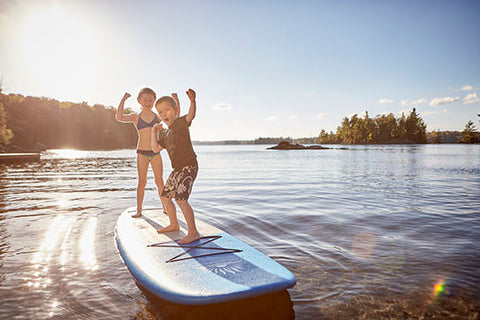 kids enjoying stand up paddle boarding