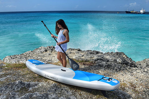 a stand up paddle boarder holding a carbon paddle