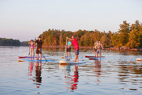 stand up paddling boarding on a lake with an alloy paddle